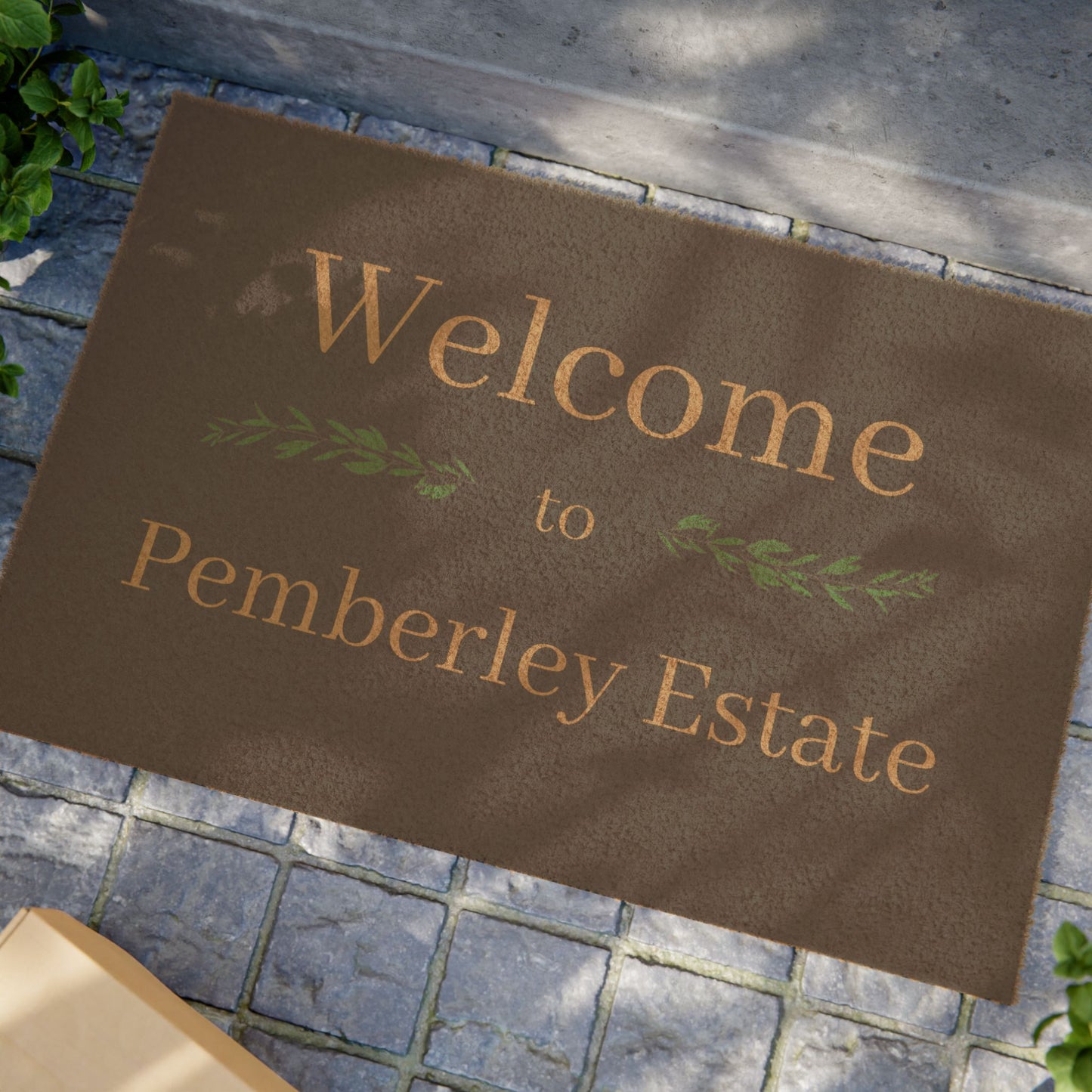 Welcome to Pemberley Estate text on front porch mat - natural with tan text in use at a front door