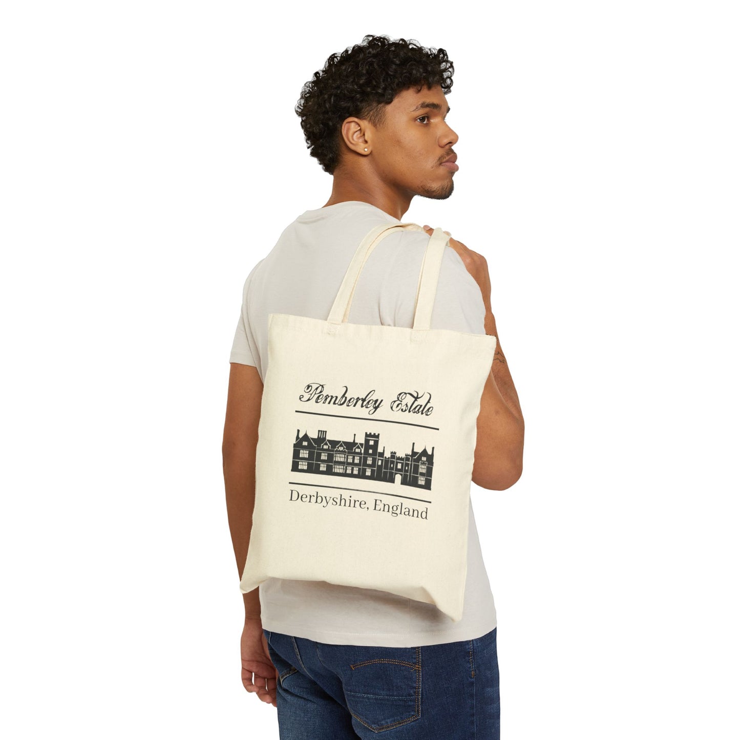 Pemberley Estate Derbyshire England with building black text on beige tote bag - male holding