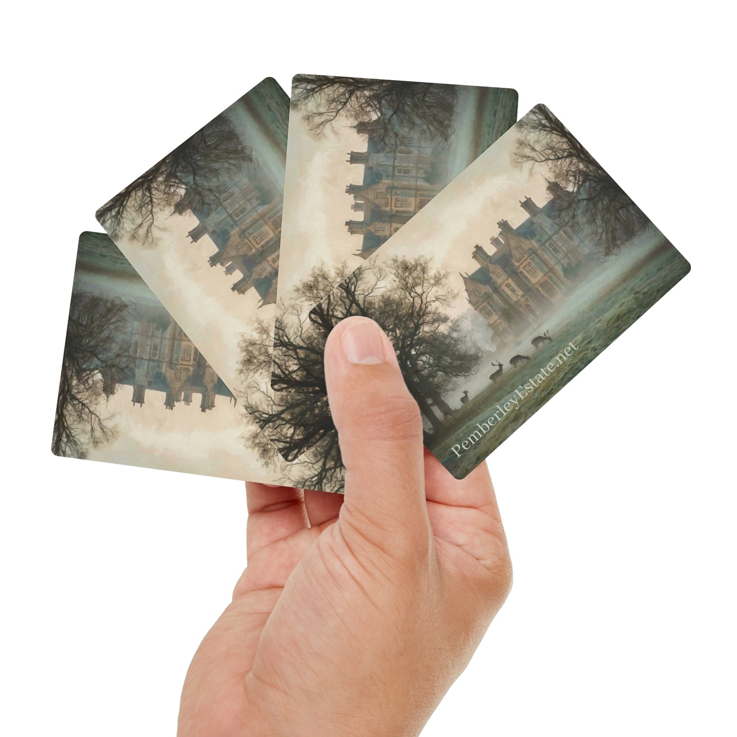 Hand holding four scenic cards with a castle and tree design, brand 'Pemberley' visible.