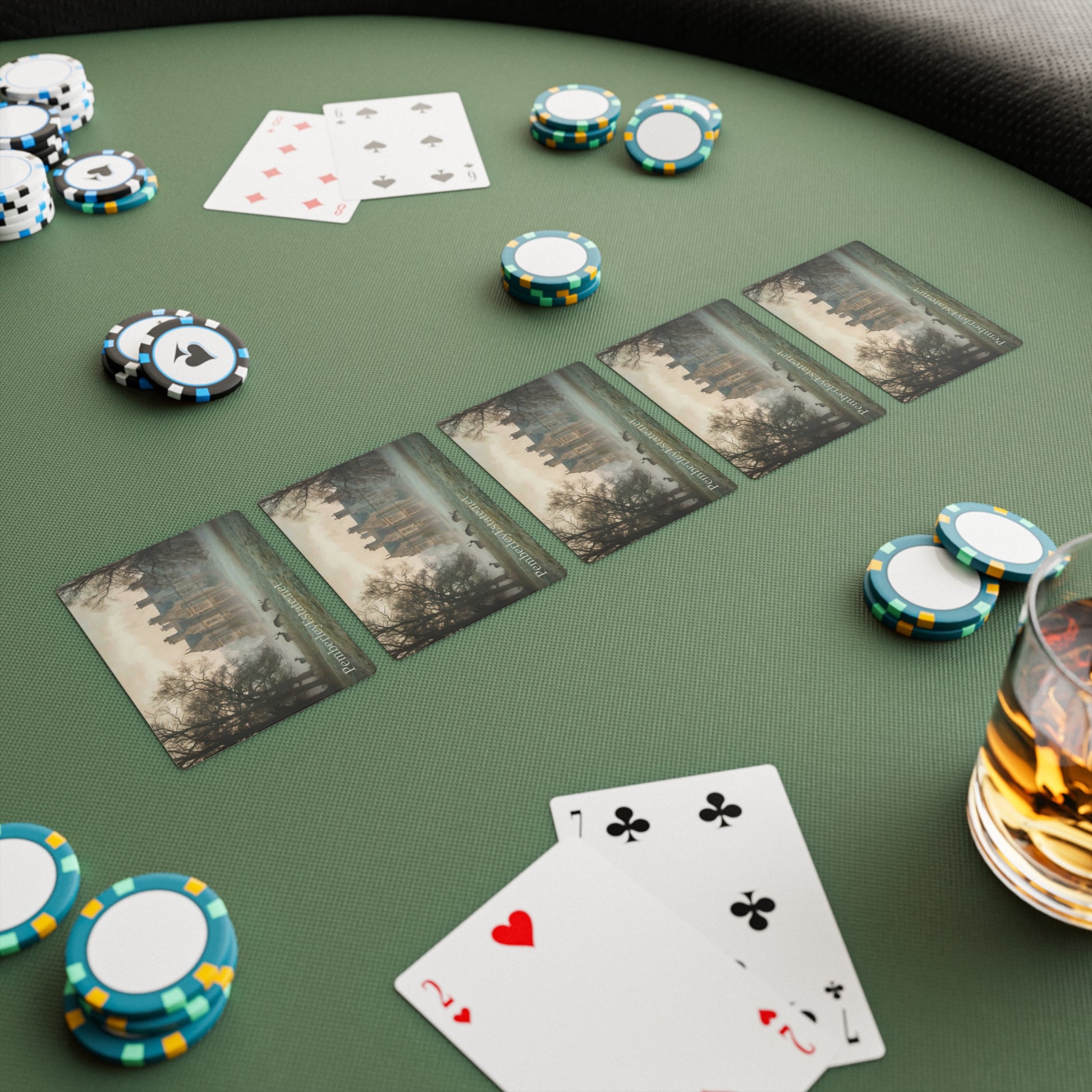 Poker game setup with cards and chips on a green table.