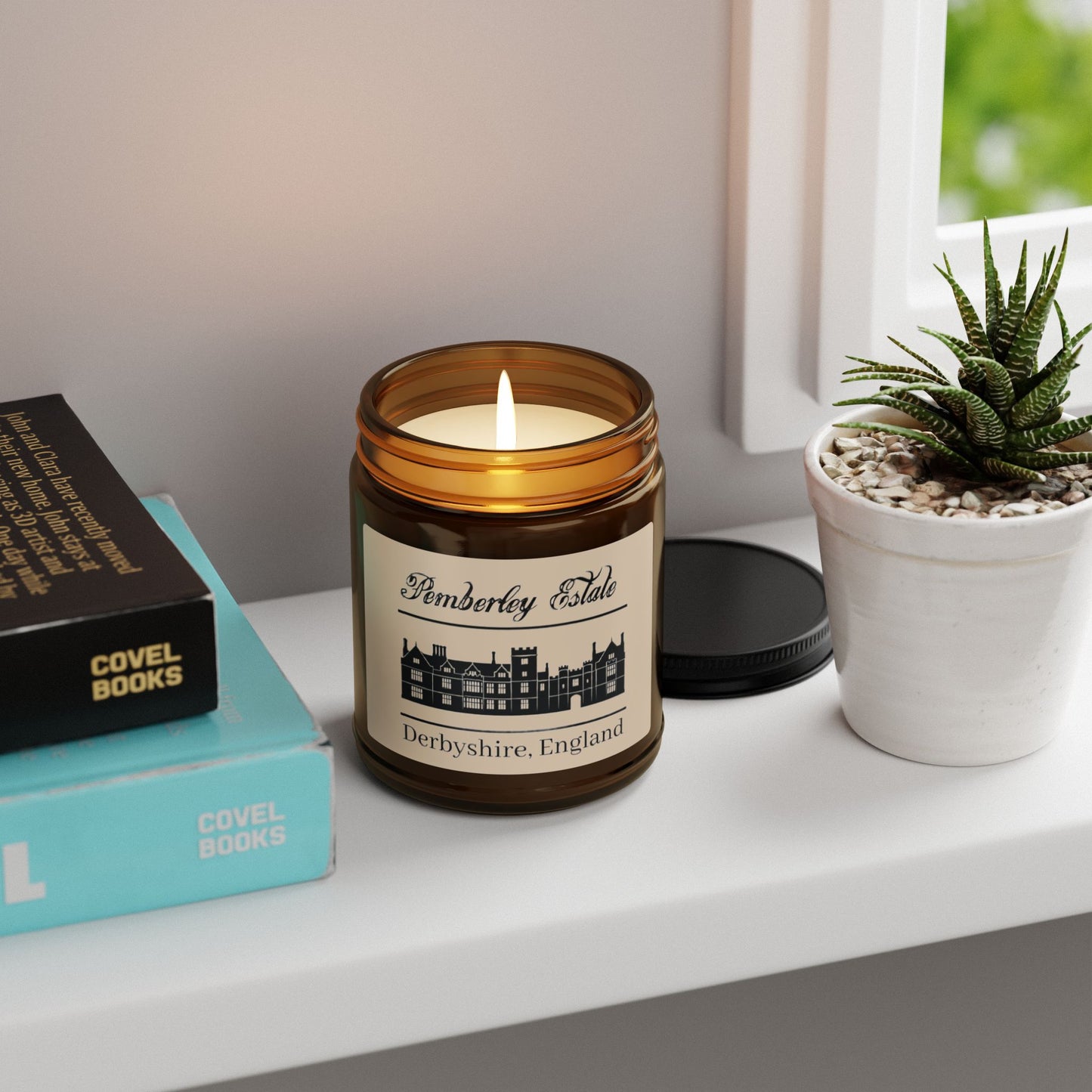 Pemberley Estate Derbyshire England with building black text on candle lit on shelf