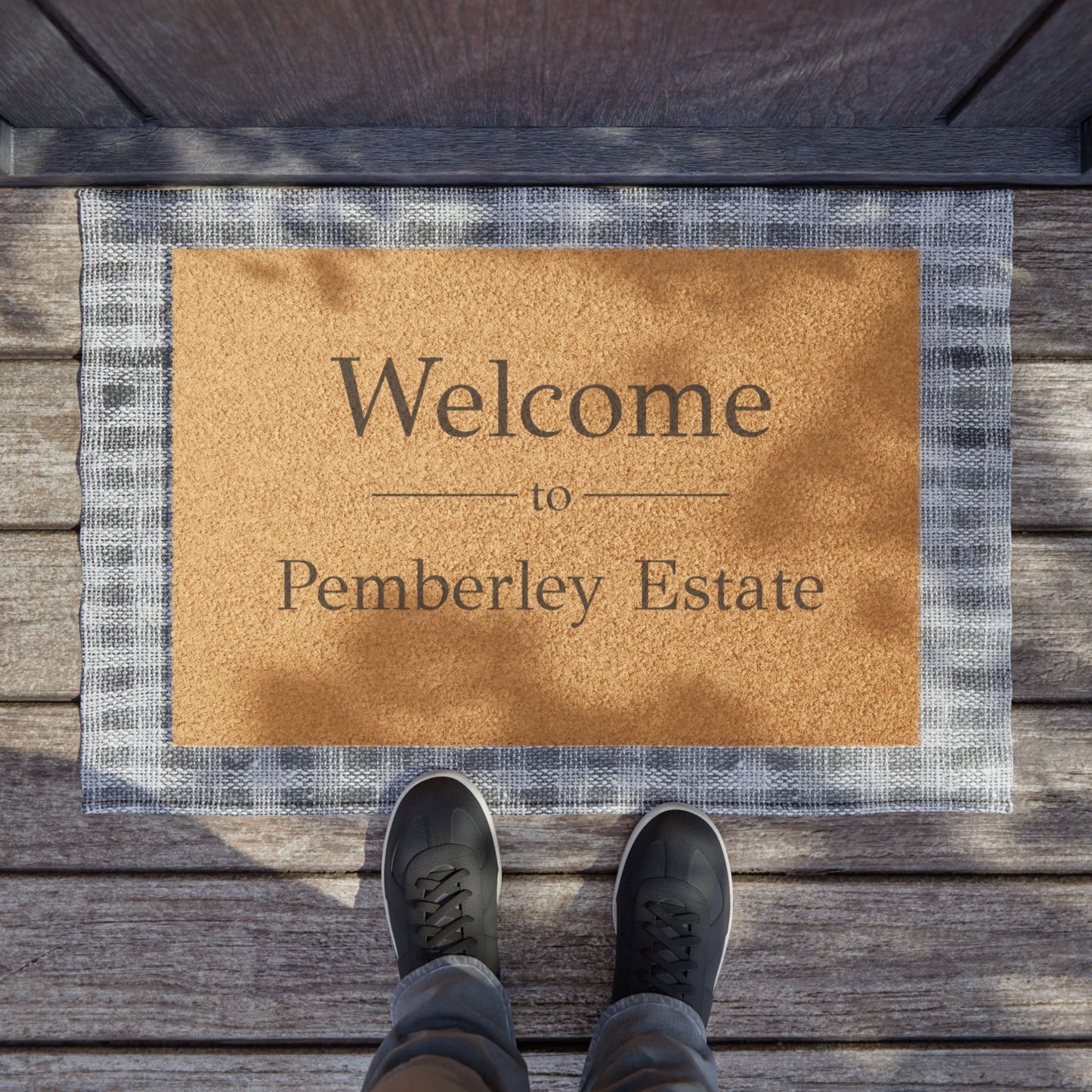 Welcome to Pemberley Estate door mat - black text on natural fiber on porch