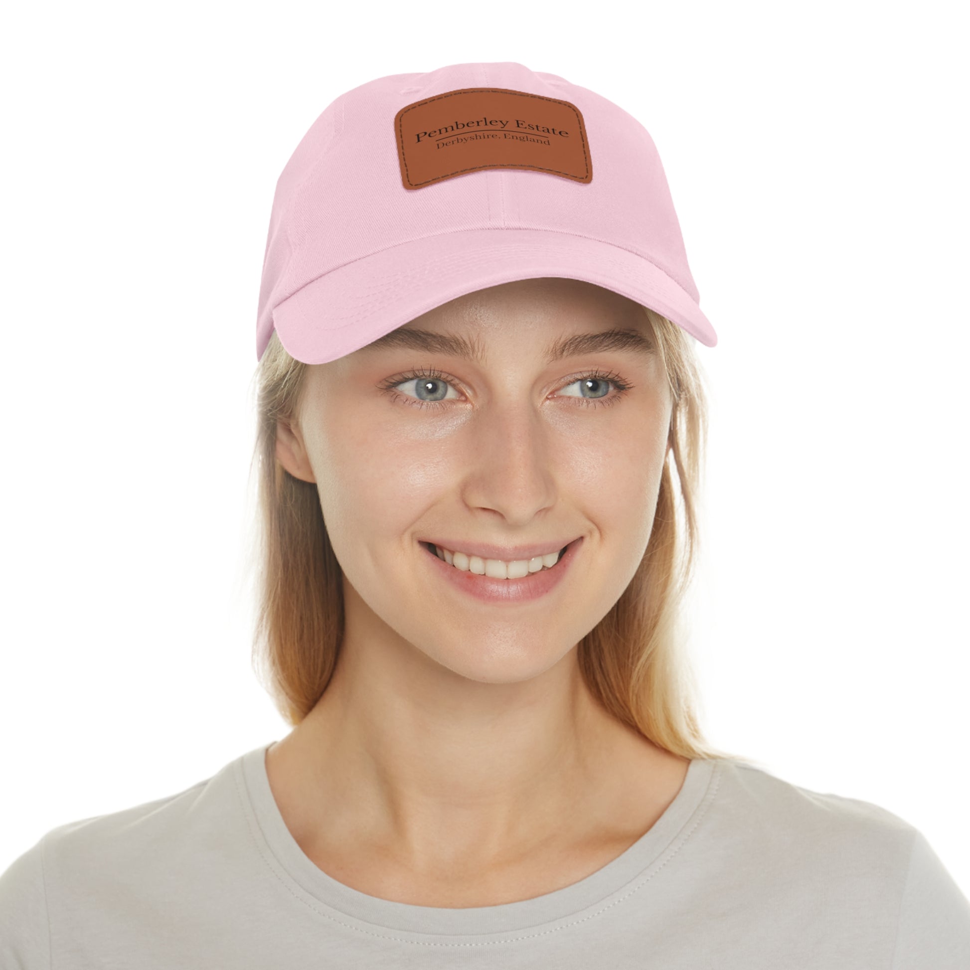 Person wearing a pink cap with a brown patch on a white background