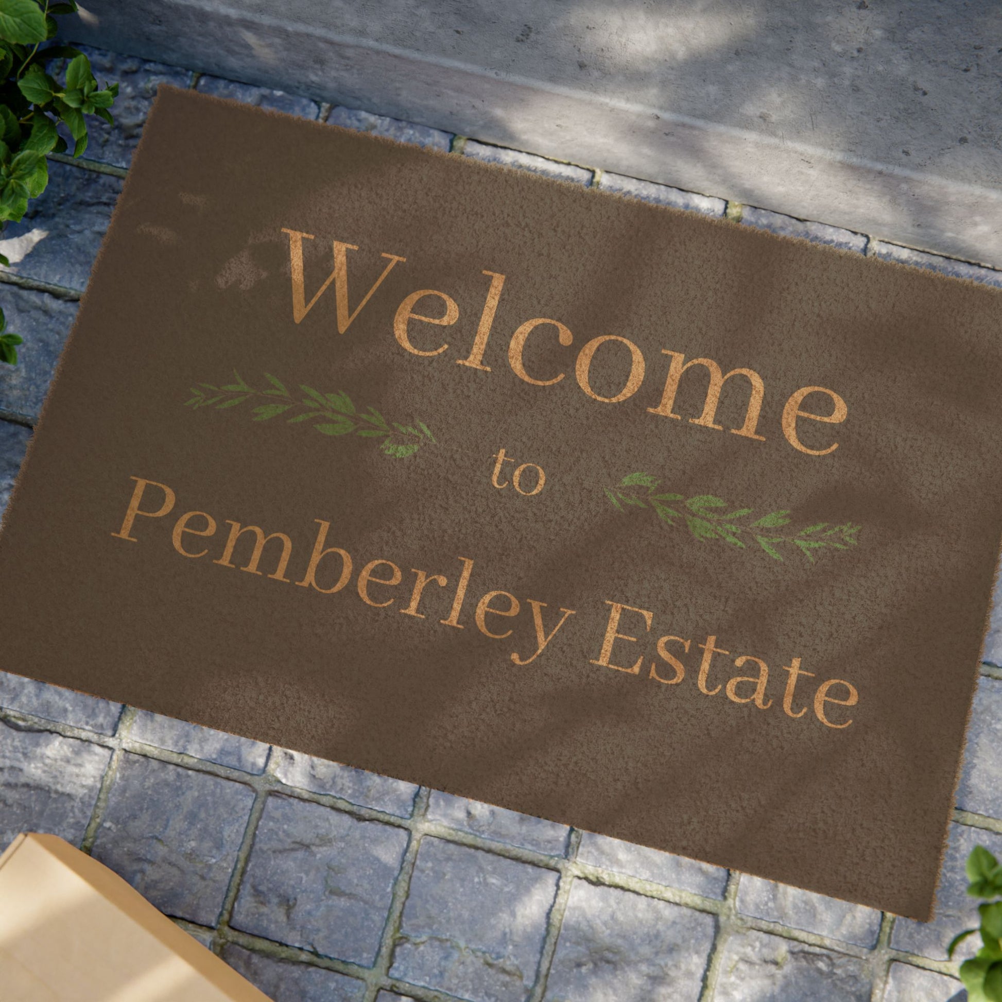 Welcome to Pemberley Estate text on front porch mat - natural with tan text in use at a front door