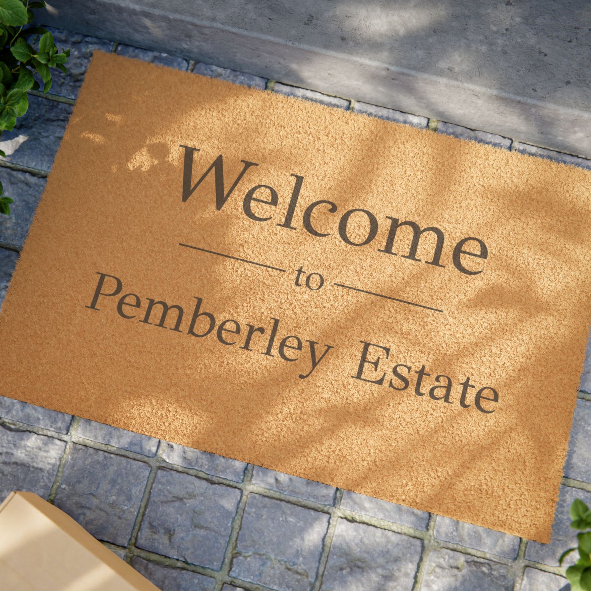Welcome to Pemberley Estate door mat - black text on natural fiber angle