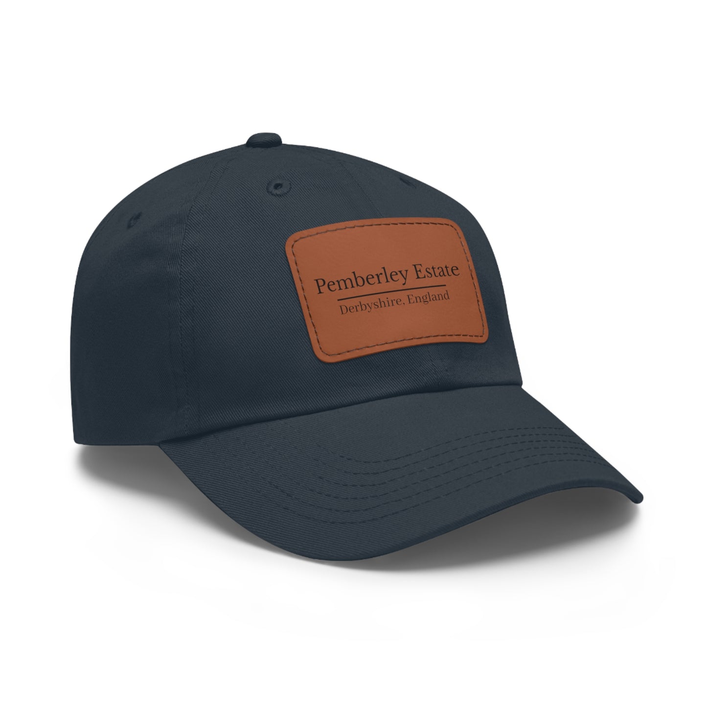 Navy blue cap with a brown leather patch featuring a logo on a white background