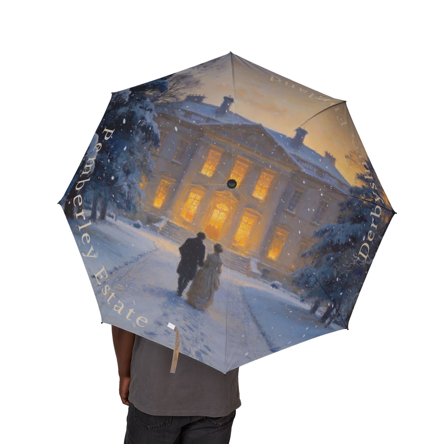 Umbrella with a design of a couple in front of a large building at night, held by a person.