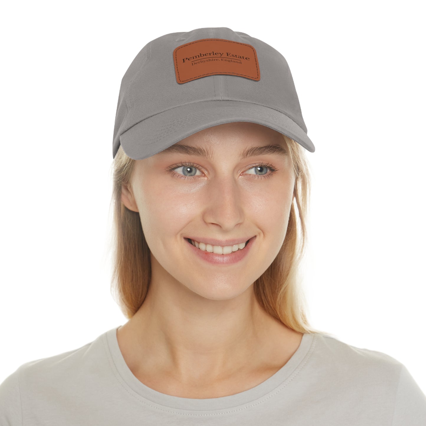 Woman wearing a gray cap with a brand logo on a white background