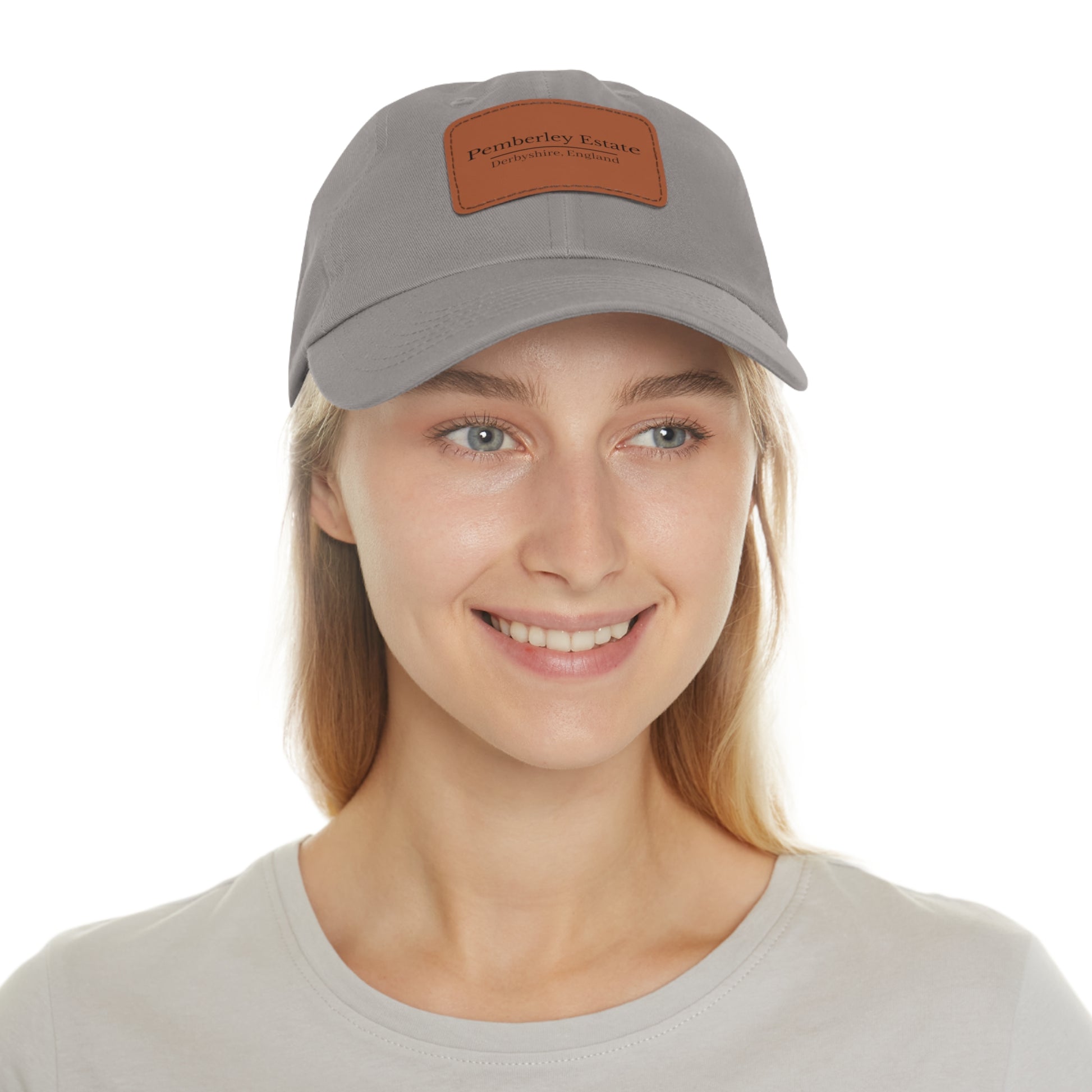 Woman wearing a gray cap with a brand logo on a white background