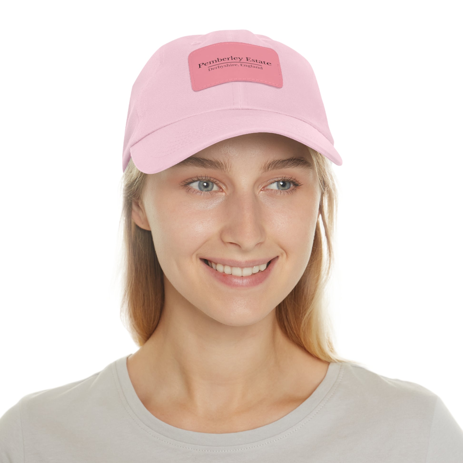 Person wearing a pink cap with logo on a white background