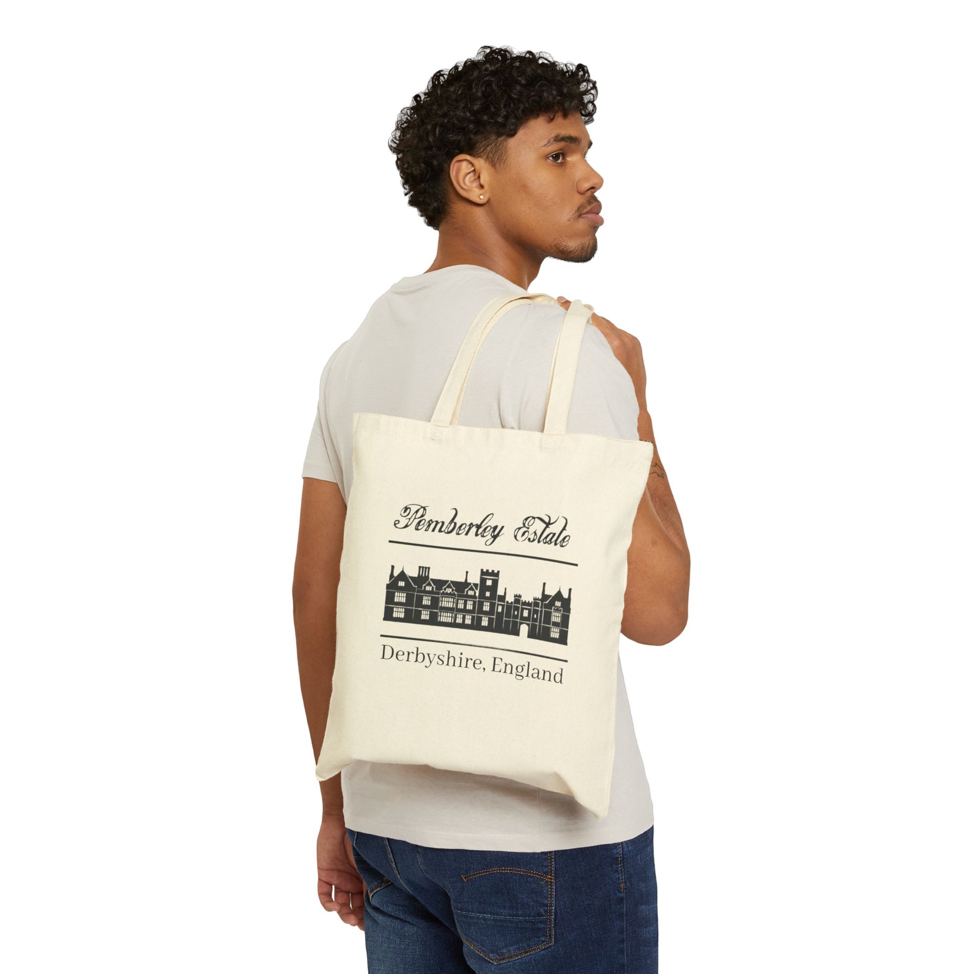 Pemberley Estate Derbyshire England with building black text on beige tote bag - male holding