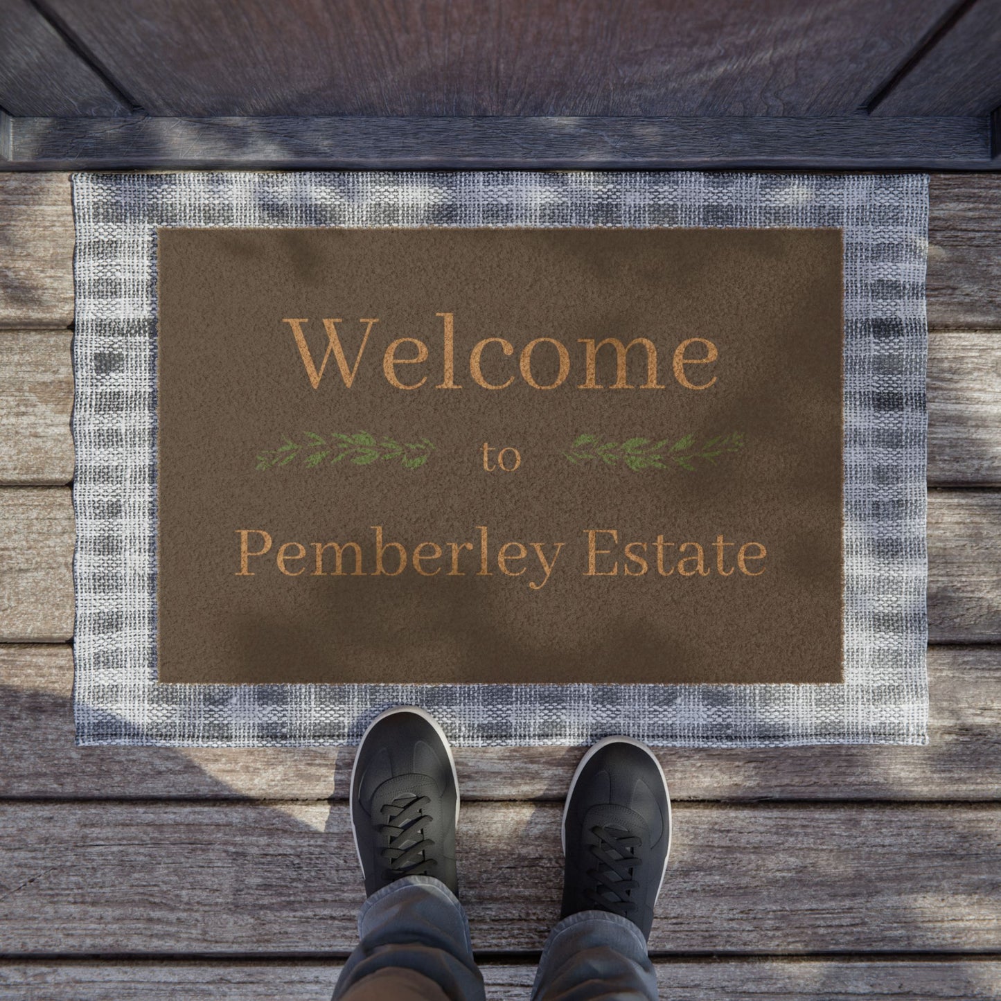 Welcome to Pemberley Estate text on front porch mat - natural with tan text in use at a front door