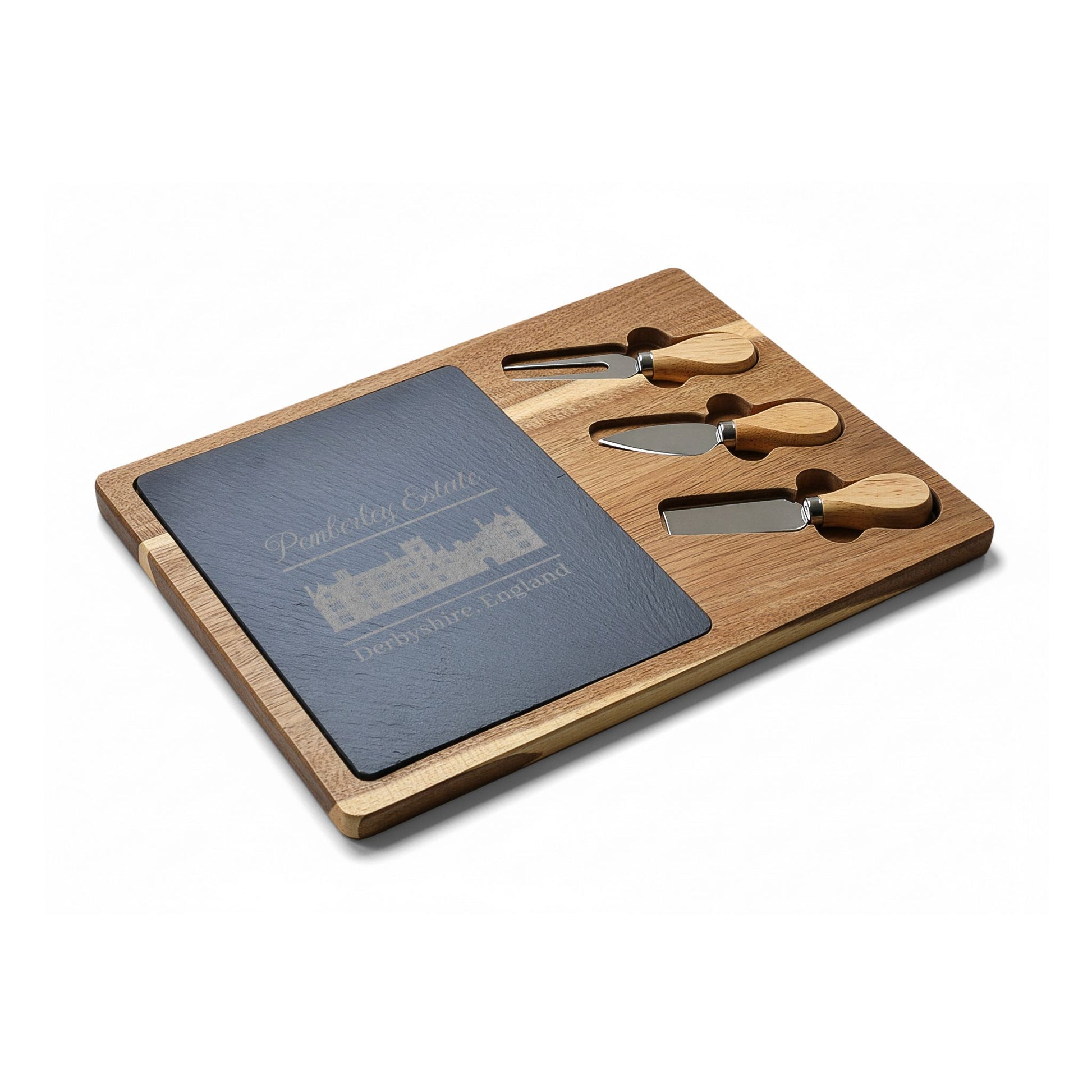 Pemberley Estate Derbyshire England with building etching on charcuterie board with utensils angle
